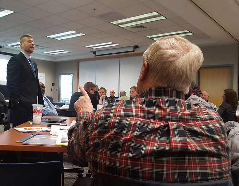 A group of people in a discussion held in a conference room.