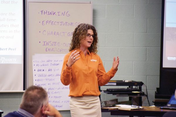 Lynda teaching while wearing an orange VCPI shirt